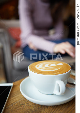 Two cups of coffee and cake on the table,latte art 28478216