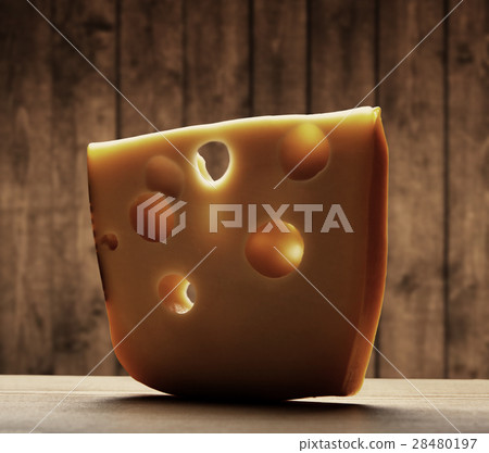 slice of cheese on wooden background 28480197
