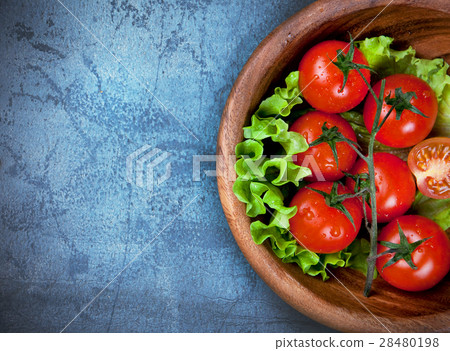 wooden bowl with cherry tomatoes on blue table wooden bowl with cherry tomatoes on blue table 28480198