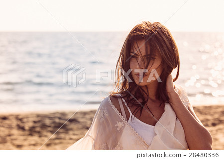 Young female enjoying sunny day on tropical beach 28480336