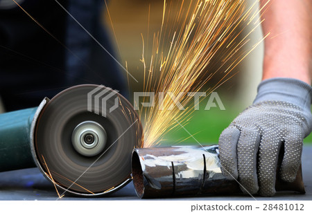 Worker cutting metal with grinder Worker cutting metal with grinder 28481012