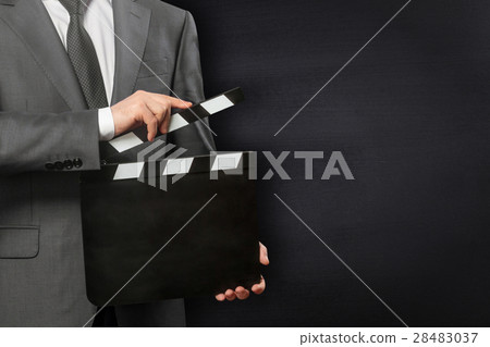 Man holding movie clapper board 28483037