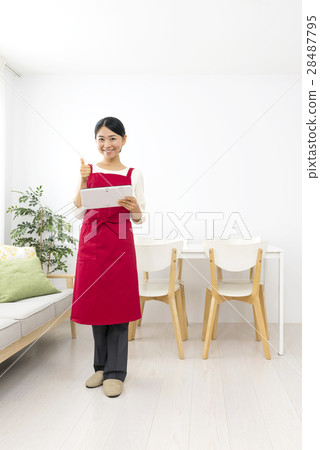 A smiley woman holding a tablet and doing a good sign A smiley woman holding a tablet and doing a good sign 28487795