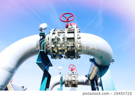 Steel pipelines and valves against blue sky 28493728