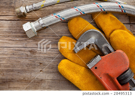 Set of plumbing and tools on the wooden table 28495313