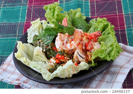 Spicysour mixed herb salad with shrimp served . Spicysour mixed herb salad with shrimp served . 28498137