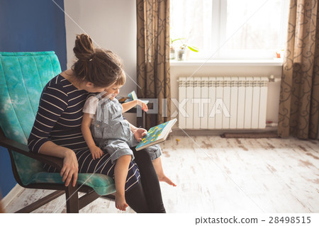 young pregnant mother and son reading a book young pregnant mother and son reading a book 28498515