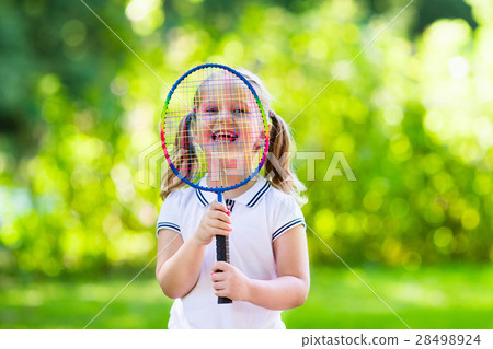 Kid playing badminton or tennis outdoor in summer 28498924