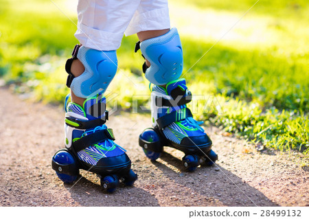 Kids roller skating in summer park Kids roller skating in summer park 28499132
