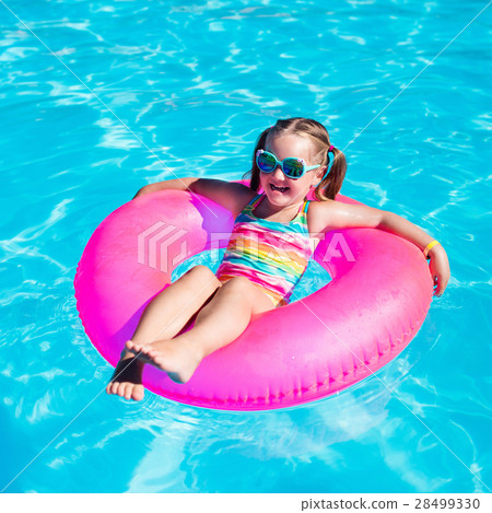 Little girl with toy ring in swimming pool Little girl with toy ring in swimming pool 28499330