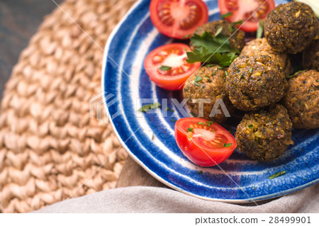 Falafel with tomato and celery on a blue plate Falafel with tomato and celery on a blue plate 28499901