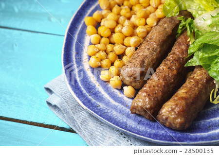 Chevanchichi with lettuce and chick-pea on plate Chevanchichi with lettuce and chick-pea on plate 28500135