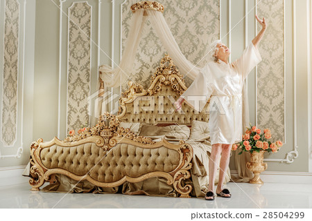 Elegant mature lady waking up at home Elegant mature lady waking up at home 28504299