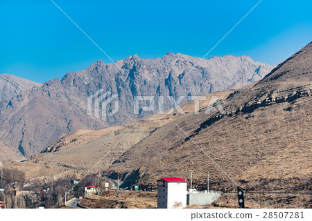 Small building afore high mountains Small building afore high mountains 28507281