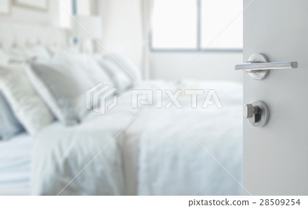 opened white door to a classic white bedroom opened white door to a classic white bedroom 28509254