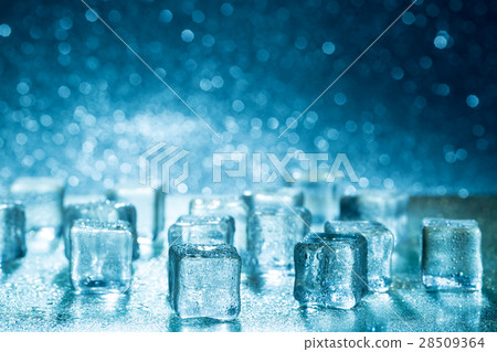 Melting ice cubes on glass table 28509364