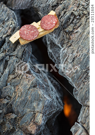 Barbecue over the fire in crack of frozen lava Barbecue over the fire in crack of frozen lava 28511684