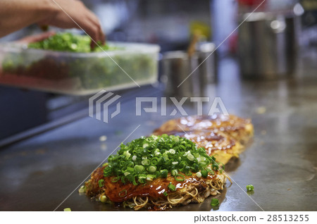 Male burning Hiroshima specialty okonomiyaki Male burning Hiroshima specialty okonomiyaki 28513255