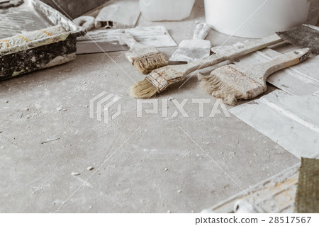 Plastering tools on cement background. 28517567