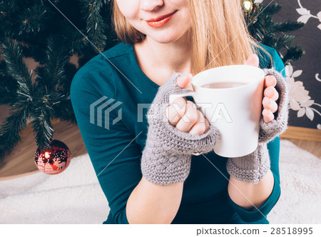 Beautiful girl with a cup of tea in his hands Beautiful girl with a cup of tea in his hands 28518995