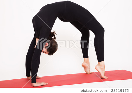 Beautiful athletic girl in black suit doing yoga Beautiful athletic girl in black suit doing yoga 28519175