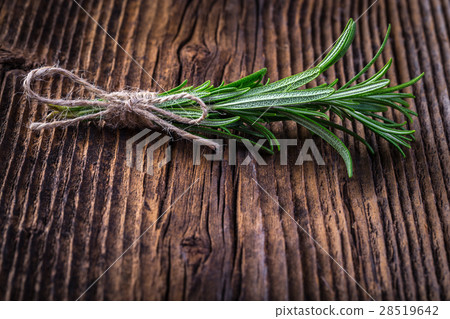 Fresh fragrant rosemary branch on wooden table 28519642