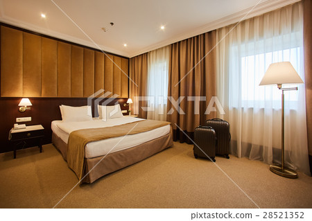 traveling bag in the hotel room 28521352