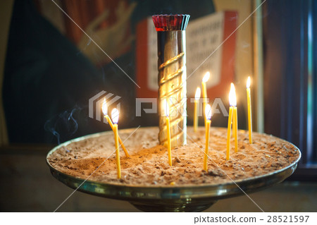 The candle flame in orthodox church, close up The candle flame in orthodox church, close up 28521597