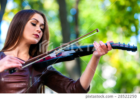 Woman perform music on violin park outdoor. Girl Woman perform music on violin park outdoor. Girl 28522250