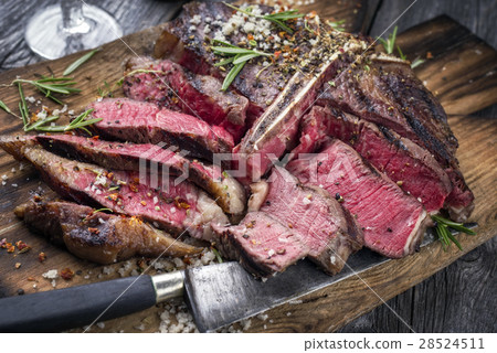 Barbecue Wagyu T-Bone Steak sliced on Cutting Boar 28524511
