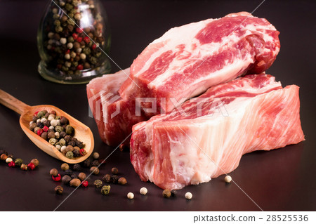 piece of pork on a dark background with peppercorn piece of pork on a dark background with peppercorn 28525536