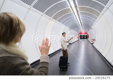 Senior couple in hallway of subway saying goodbye 28526275