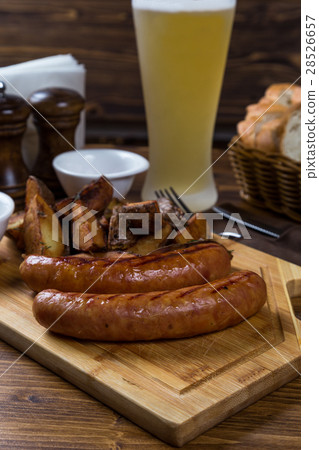 hot sausages serving on wooden board with beer hot sausages serving on wooden board with beer 28526657