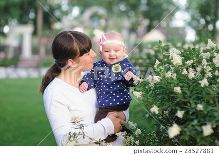 mom and little baby daughter walking in the spring mom and little baby daughter walking in the spring 28527881
