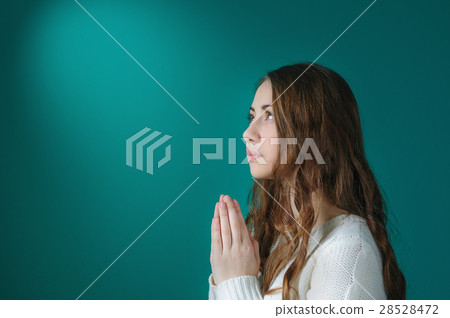 young woman praying in the room 28528472