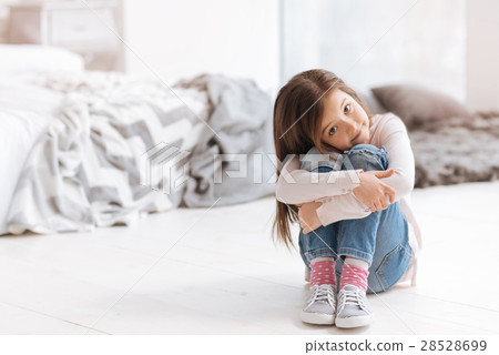 Pleasant cute girl sitting on the floor 28528699