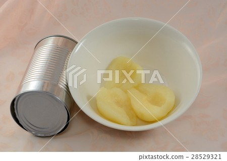 Canned peat halves in white bowl 28529321