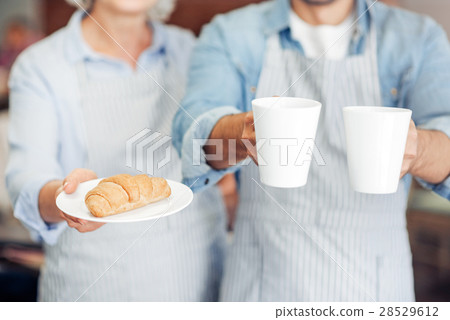Pleasant hospitable waiters welcoming guests Pleasant hospitable waiters welcoming guests 28529612