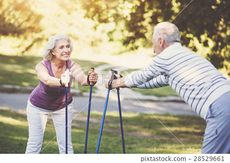 Cheerful elderly woman standing opposite her 28529661