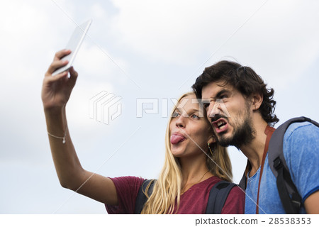 Couple taking a wacky selfie tongue out 28538353