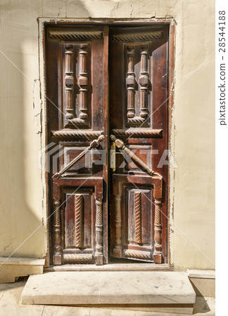 Ancient wooden door in Old city. Baku Ancient wooden door in Old city. Baku 28544188