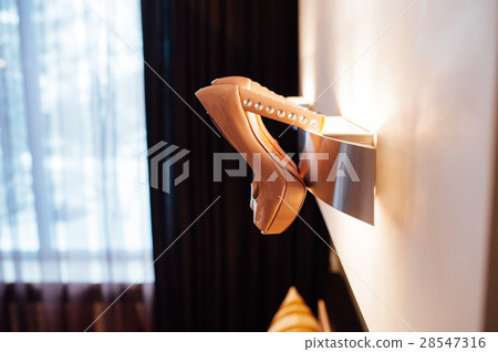 Beautiful bridal beige shoes hang on the wall lamp Beautiful bridal beige shoes hang on the wall lamp 28547316