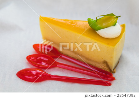 homemade mango cheesecake with red spoons homemade mango cheesecake with red spoons 28547392