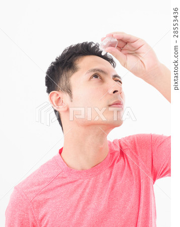 A young man referring to eye drops A young man referring to eye drops 28553436