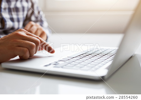 Man using touchpad on notebook with his finger 28554260