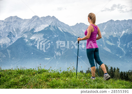 Young woman hiking in the mountains Young woman hiking in the mountains 28555391