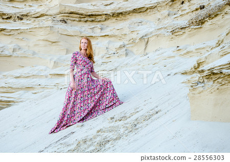 Woman wearing long dress in the desert 28556303