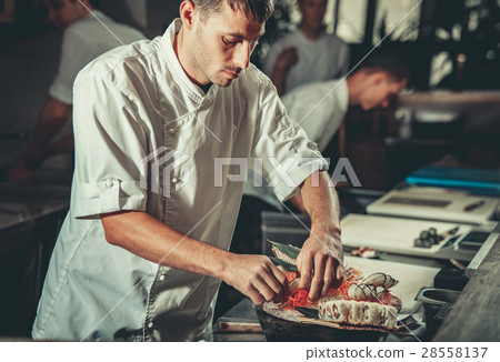 Busy chef at work in the restaurant kitchen 28558137