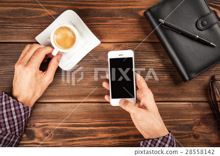 Male hands holding a smartphone 28558142