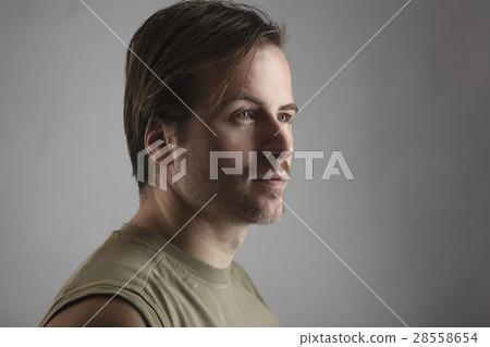 Portrait of an attractive man with green shirt Portrait of an attractive man with green shirt 28558654